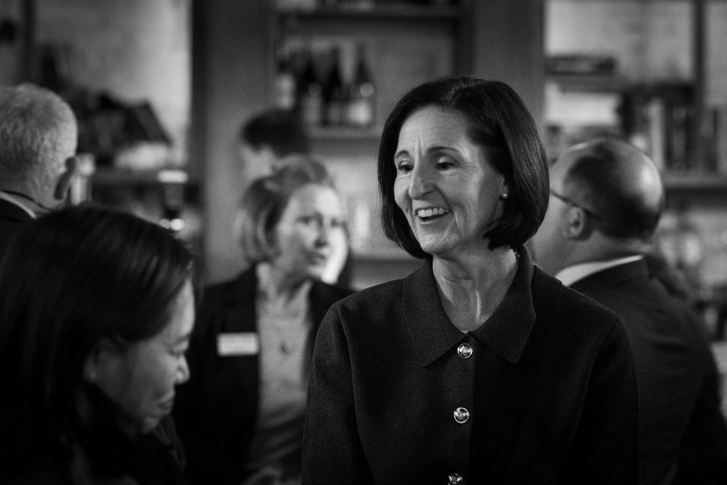 A business leader laughing warmly at a CEA Policy Summit networking reception