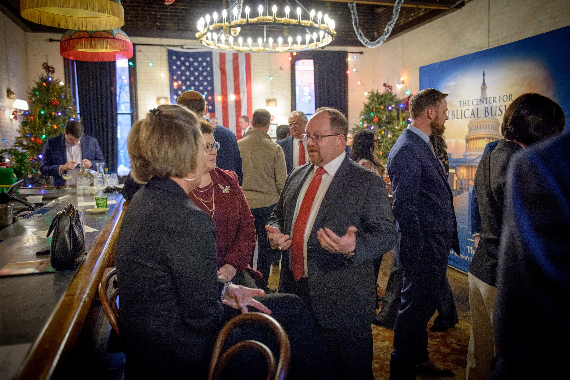 CEA Policy Summit reception with members, American flag, and BBI backdrop